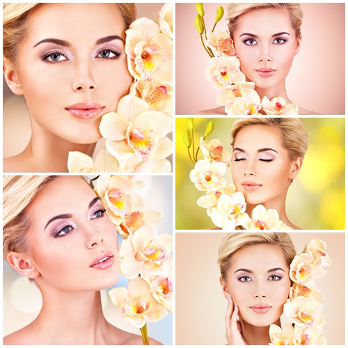 Woman with health skin and flowers at face - stock photo